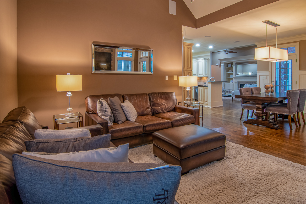 Spacious living room with modern furniture and warm lighting for a cozy atmosphere.